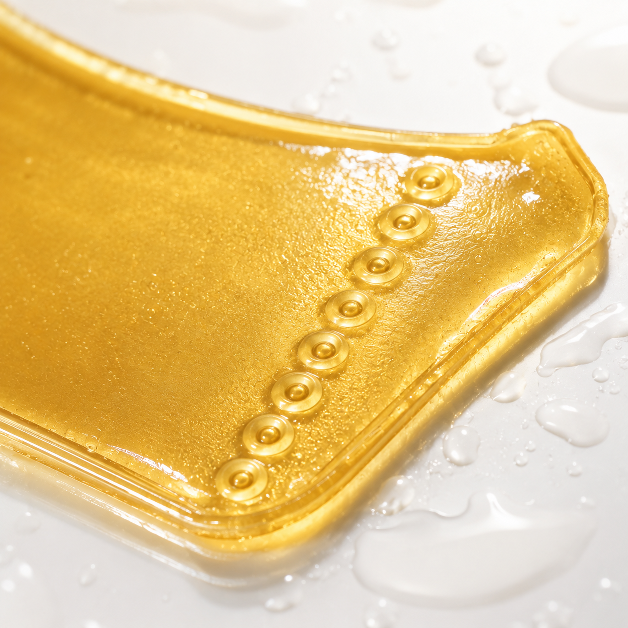 Close-up of gold collagen neck mask hydrogel texture