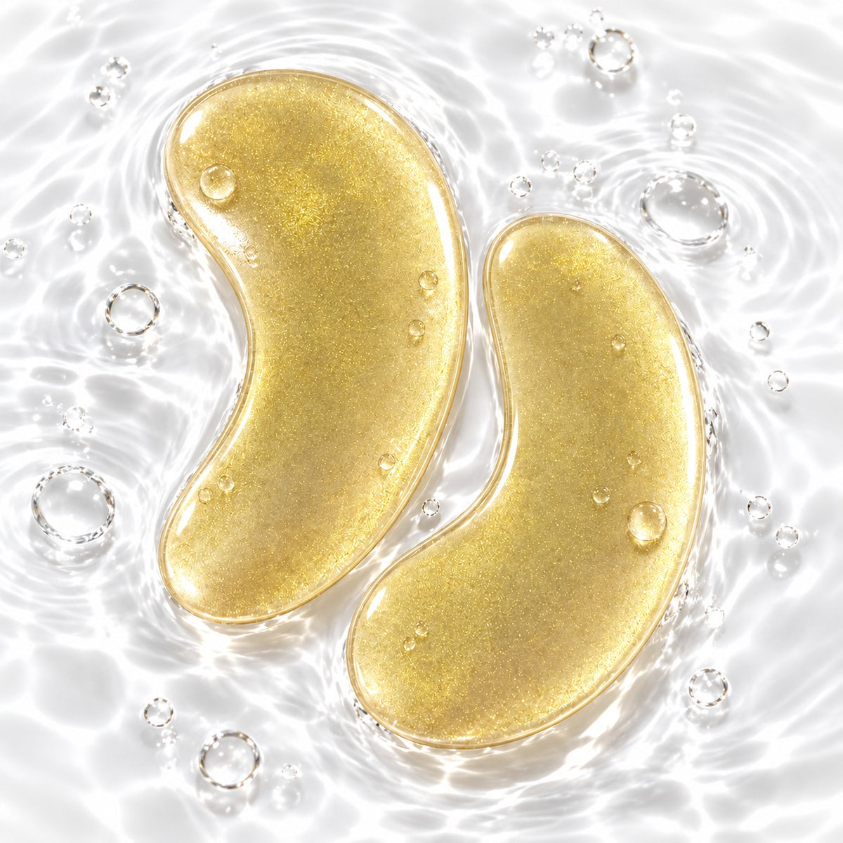 Champagne gold hydrogel eye patches with water droplets and hydrating gel texture
