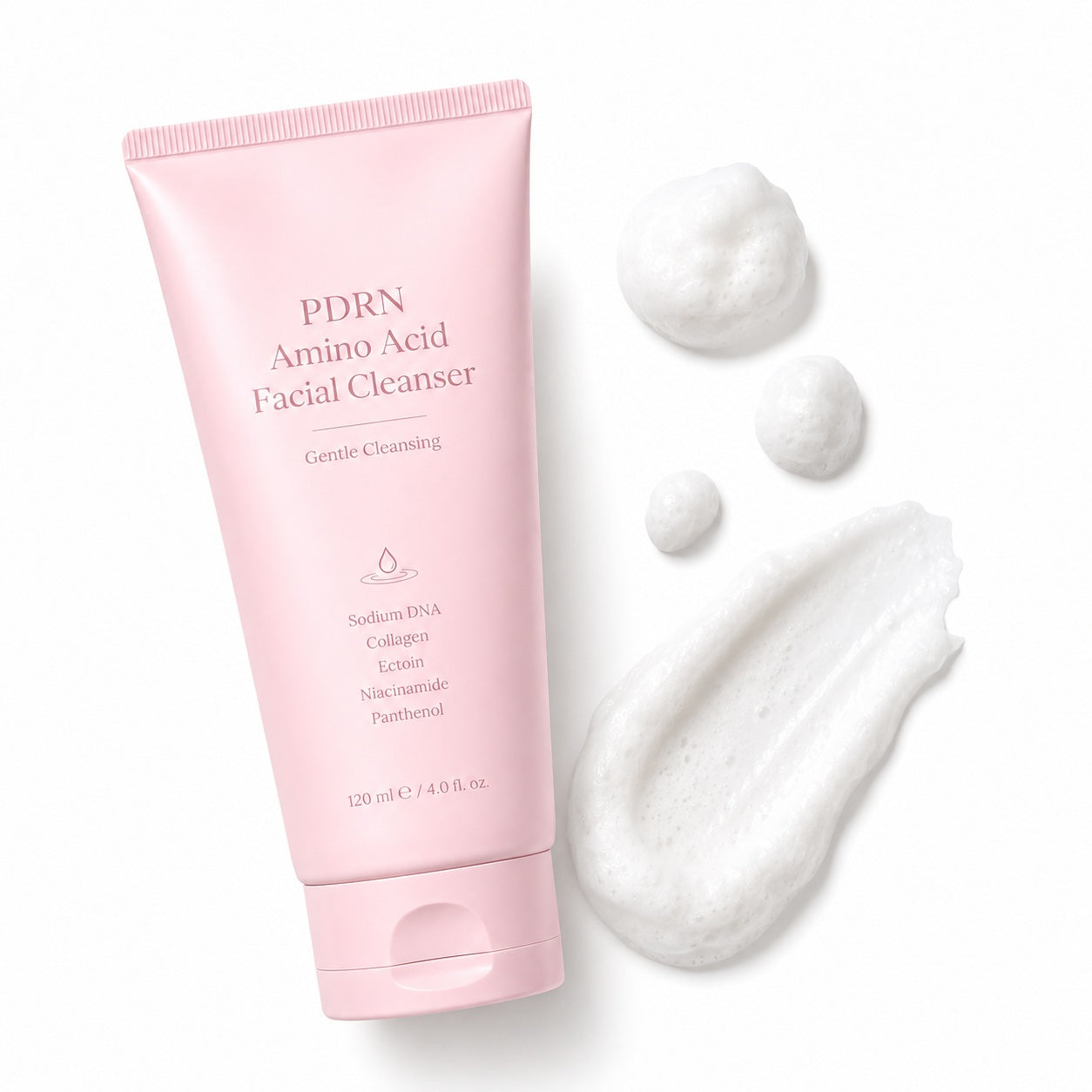 White creamy texture of PDRN amino acid facial cleanser beside the pink tube
