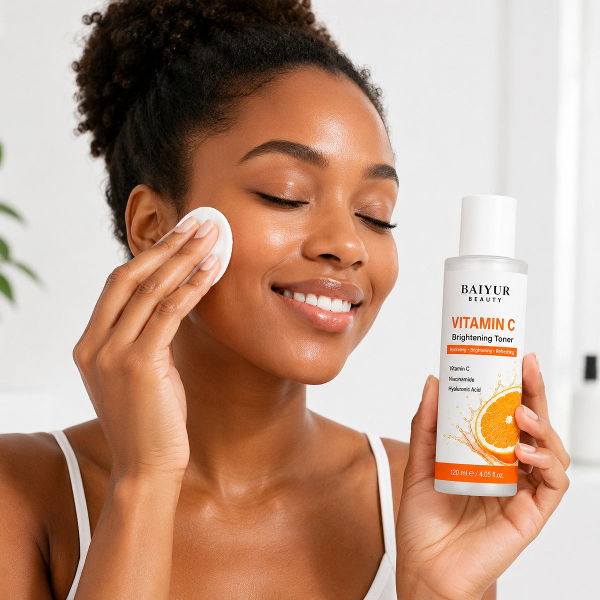 Black model using Baiyur Beauty Vitamin C Brightening Toner with cotton pad for glowing refreshed skin